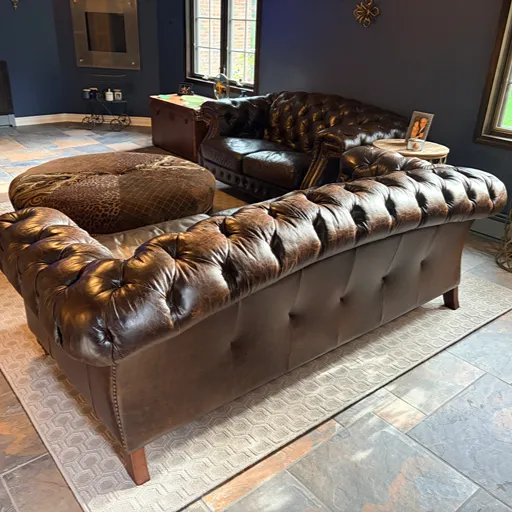 Brown couch with ottoman and living room tile installation MI