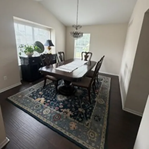 Dark hardwood dining room flooring and area rug Michigan